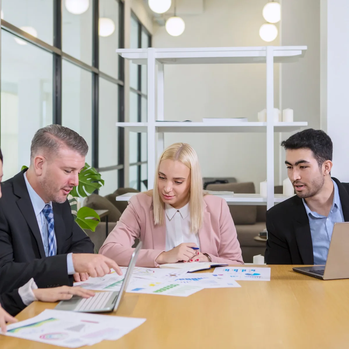 Colleagues discussing work around a table