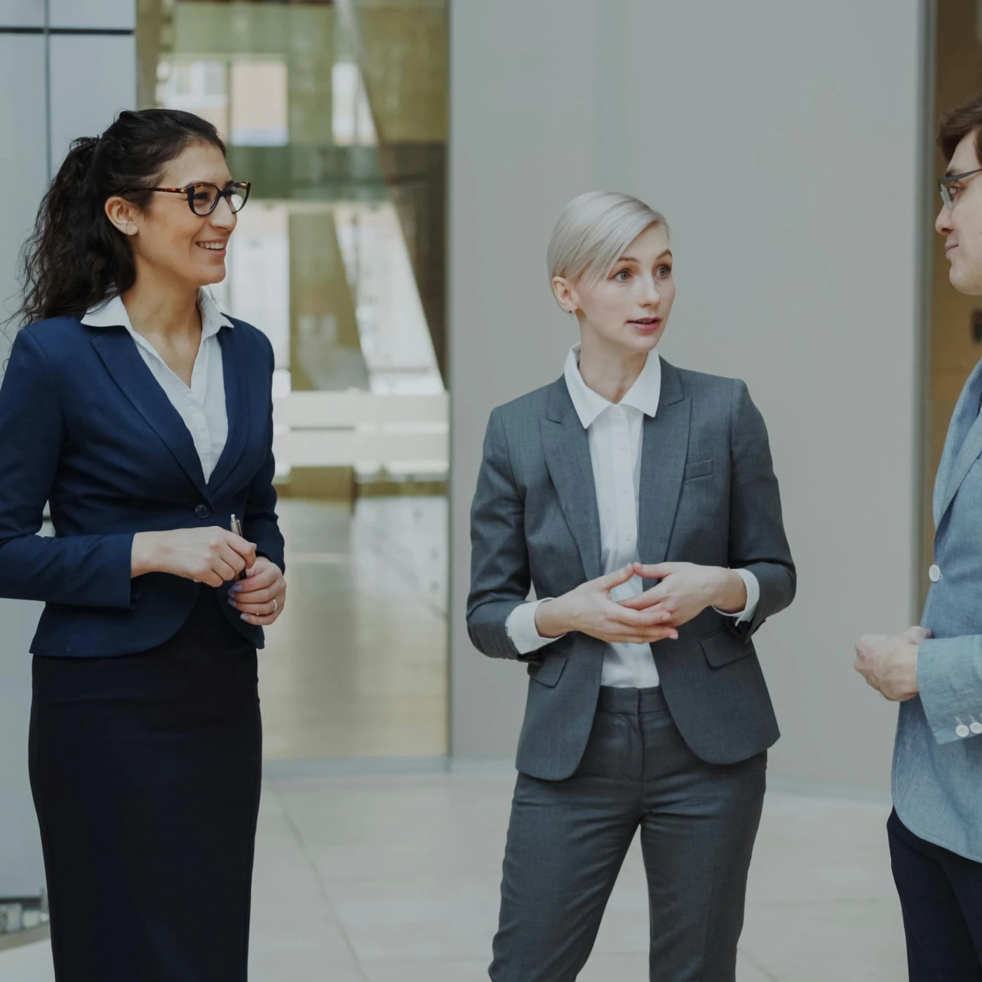 Two professionals discussing work in a bright office.