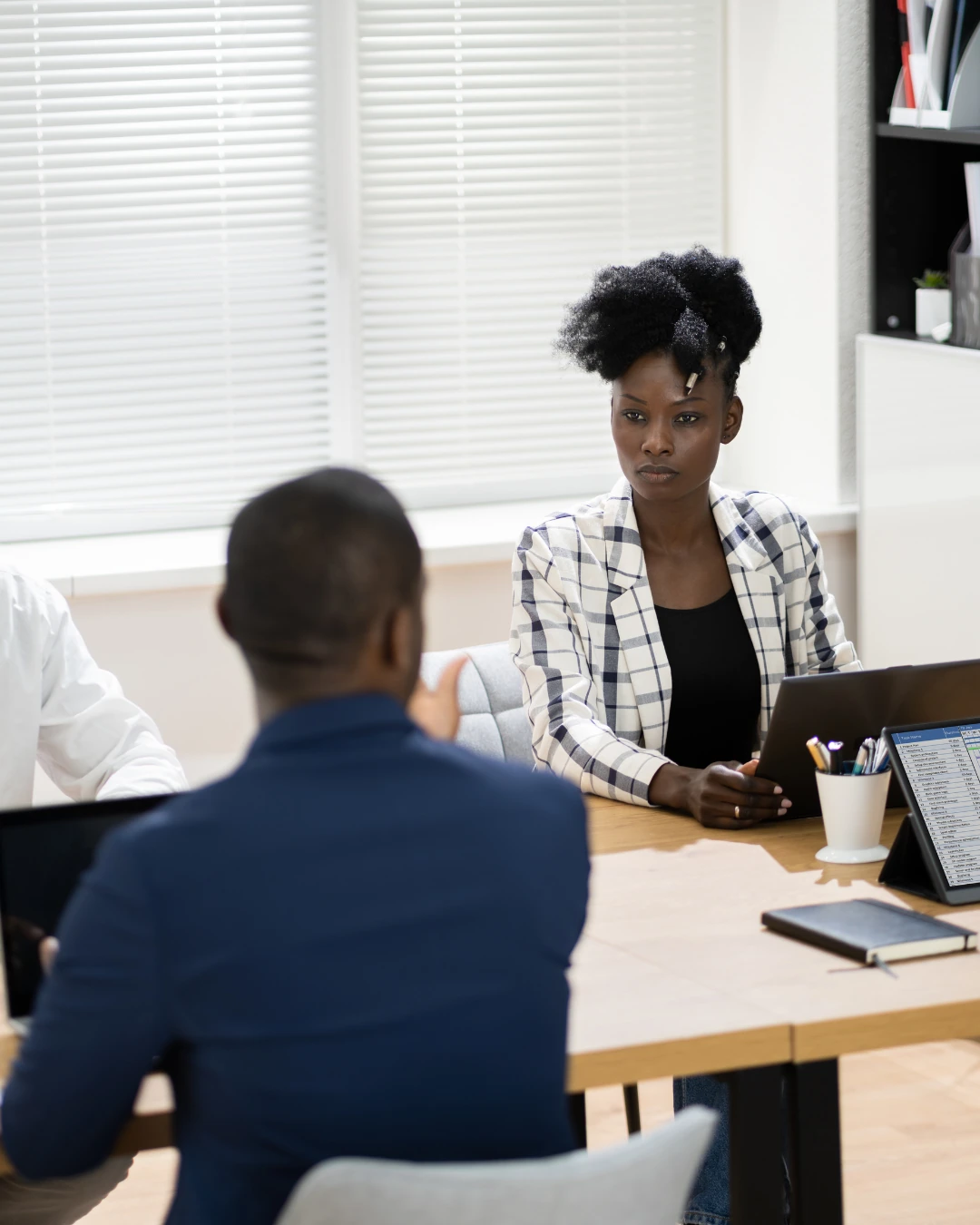 Professionals discussing work across an office table