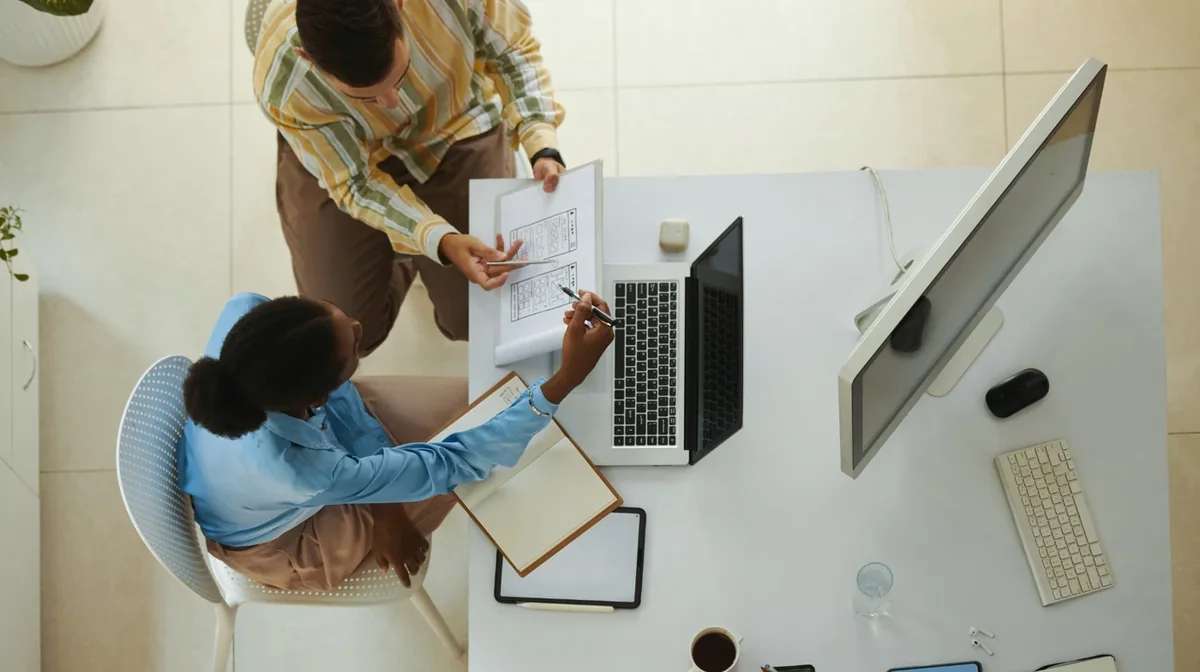An overhead view of a workstation and digital devices