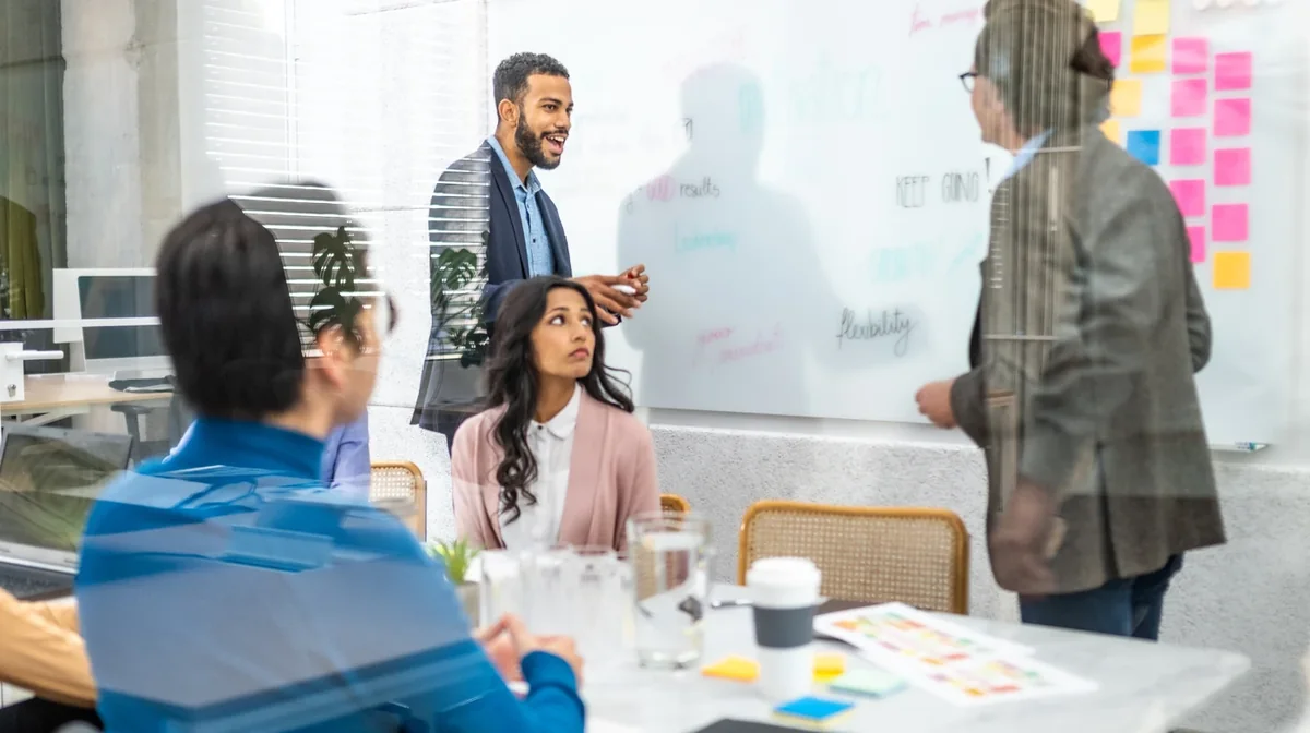 A presenter discussing a project with colleagues