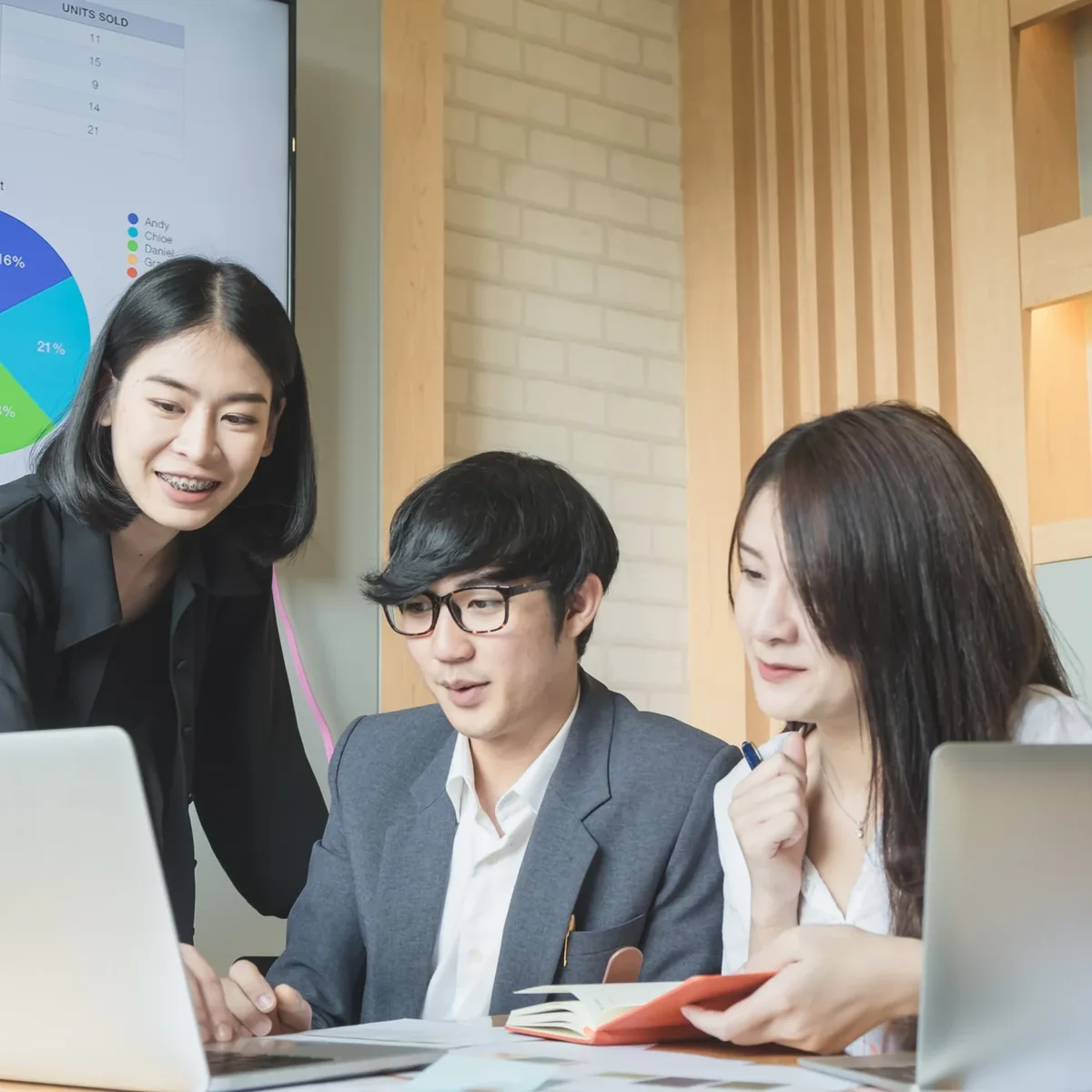 Colleagues reviewing information on a computer screen