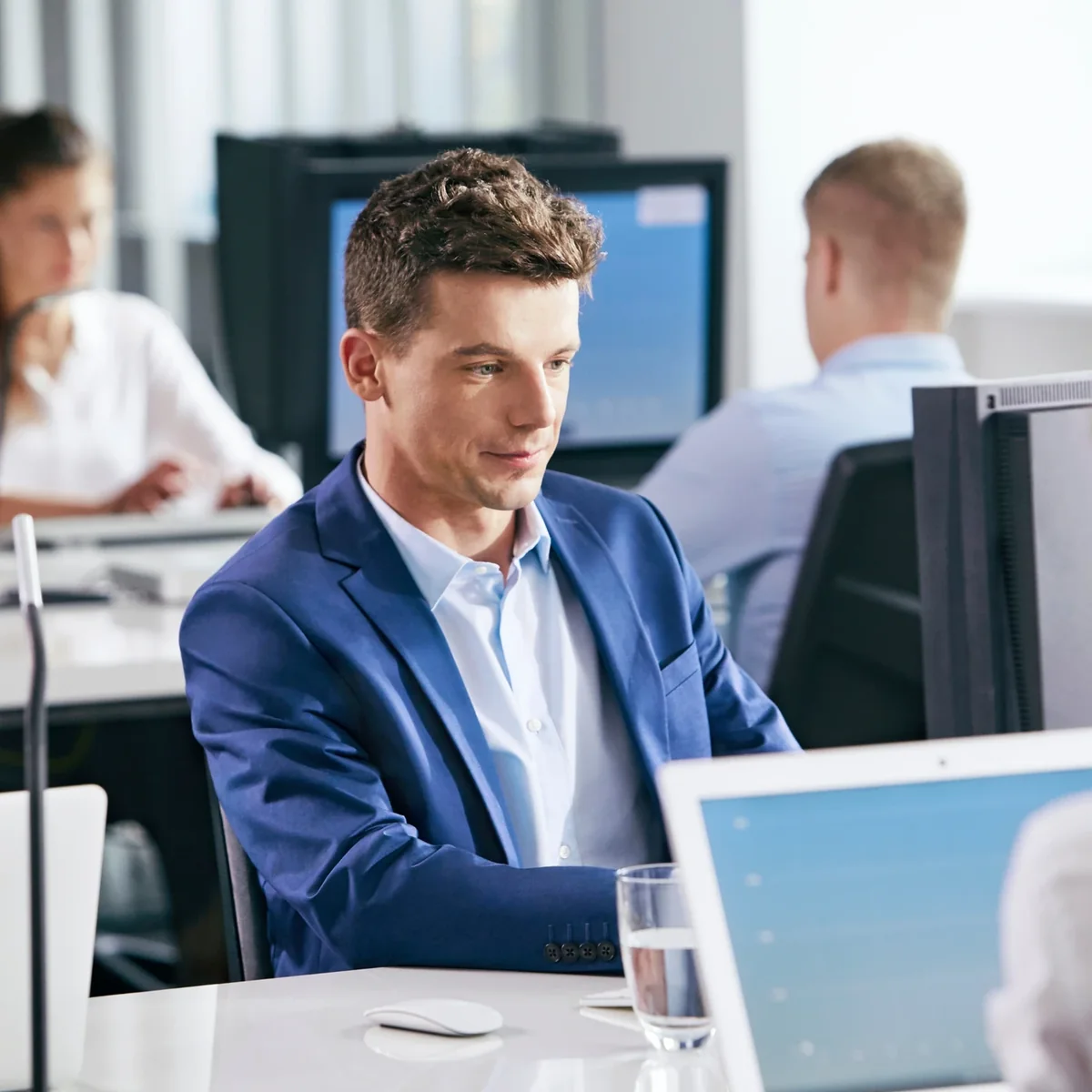 An IT professional working at a desktop computer