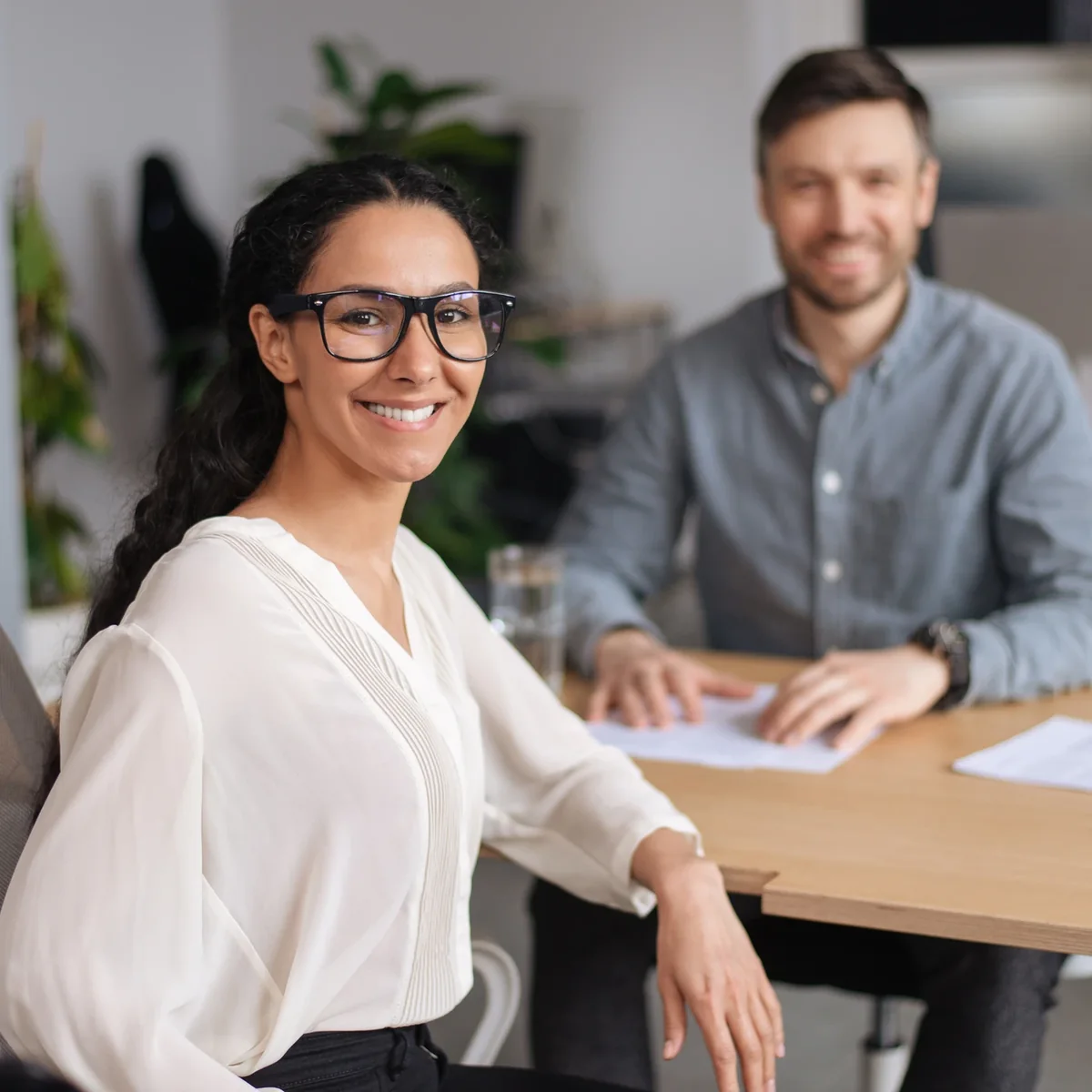 A professional with colleagues at a shared table