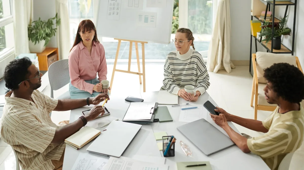A facilitator discussing work with a group